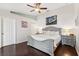 Spacious main bedroom features a ceiling fan, an art accent wall, and hardwood flooring at 6724 Clair Shore Dr, Apollo Beach, FL 33572