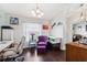 Bright home office with dark hardwood floors, a desk, a stylish purple chair and modern decor accents at 6724 Clair Shore Dr, Apollo Beach, FL 33572