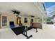 Spacious covered patio with ceiling fans and workout area, perfect for relaxing or exercising at 6724 Clair Shore Dr, Apollo Beach, FL 33572