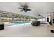 Relaxing screened pool with a seating area and ceiling fans for ultimate comfort at 6724 Clair Shore Dr, Apollo Beach, FL 33572