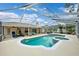 Inviting screened pool with spa, complemented by an outdoor seating area and space for exercising at 6724 Clair Shore Dr, Apollo Beach, FL 33572