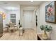 Inviting entryway featuring modern decor, light wood floors, and access to dining and living areas at 6977 Hawksbury St, Englewood, FL 34224