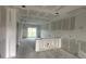 Unfinished living area showcasing drywall and sliding glass doors opening to the backyard at 6977 Hawksbury St, Englewood, FL 34224