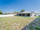 Large backyard featuring a white fence and a covered patio area, perfect for entertaining at 7131 Vista Way, Port Richey, FL 34668
