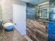 Modern bathroom featuring a vessel sink, granite counters, rain shower head and tiled walls at 7131 Vista Way, Port Richey, FL 34668