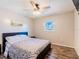Neutral-toned bedroom features modern ceiling fan, large window, and wood-look flooring at 7131 Vista Way, Port Richey, FL 34668