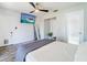 The main bedroom boasts wood floors, white walls and modern TV for your enjoyment at 7131 Vista Way, Port Richey, FL 34668