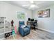 Comfortable bedroom with ceiling fan, a large window and a cozy recliner at 7131 Vista Way, Port Richey, FL 34668