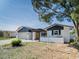 Charming single-Gathering home with a well-maintained lawn and a welcoming yellow front door at 7131 Vista Way, Port Richey, FL 34668