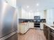 Kitchen area is well equipped with stainless steel appliances, wooden flooring, and stylish cabinetry at 7131 Vista Way, Port Richey, FL 34668
