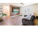 Modern living room featuring wood accent wall with mounted TV and gray wood floors at 7131 Vista Way, Port Richey, FL 34668
