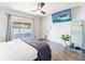 Light-filled main bedroom features luxury vinyl floors, ceiling fan, and sliding door to the lanai at 7131 Vista Way, Port Richey, FL 34668