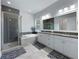 Bathroom features double vanity, a separate shower, a soaking tub, and modern finishes with tile floors at 718 W Kentucky Ave, Tampa, FL 33603