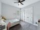 Bedroom featuring carpet, ceiling fan, window, and double doors at 718 W Kentucky Ave, Tampa, FL 33603