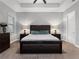 Cozy bedroom with a tray ceiling, ceiling fan, plush carpet, and a coordinated bedroom set with lamps at 718 W Kentucky Ave, Tampa, FL 33603