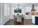 Inviting dining room with a chandelier and a large window, next to a kitchen with white cabinetry at 718 W Kentucky Ave, Tampa, FL 33603