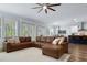 Spacious living room features a leather sectional sofa, lots of natural light, and opens to a dining area at 718 W Kentucky Ave, Tampa, FL 33603