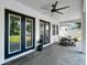 Covered patio with brick flooring, ceiling fan, dining table, and potted plant at 718 W Kentucky Ave, Tampa, FL 33603
