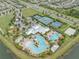 Aerial view features a community pool with slide, tennis and basketball courts, all in a verdant landscape with lakes nearby at 7238 Milestone Dr, Apollo Beach, FL 33572