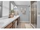 Bathroom featuring double vanity, a large walk-in shower with seamless glass, and neutral colors at 7238 Milestone Dr, Apollo Beach, FL 33572