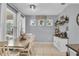 Bright dining room featuring a farmhouse table with white chairs and coffee bar near the windows at 7238 Milestone Dr, Apollo Beach, FL 33572