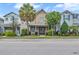 Charming two-story home featuring a covered porch with swing and manicured landscaping at 7238 Milestone Dr, Apollo Beach, FL 33572