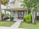 Inviting front porch with double doors, seating, and lush landscaping at 7238 Milestone Dr, Apollo Beach, FL 33572