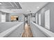 Upstairs hallway with wood floors and railings, showcasing a view of the home's interior at 7238 Milestone Dr, Apollo Beach, FL 33572