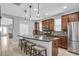 Modern kitchen featuring a central island with bar stools and stainless steel appliances at 7238 Milestone Dr, Apollo Beach, FL 33572