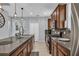 Spacious kitchen features dark cabinetry, stainless steel appliances, and a large island with a sink at 7238 Milestone Dr, Apollo Beach, FL 33572