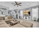 Inviting living room featuring a comfortable sectional sofa and a decorative TV console at 7238 Milestone Dr, Apollo Beach, FL 33572