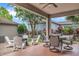 Relaxing covered patio with outdoor seating, a fire pit, and views of the beautifully landscaped backyard at 7238 Milestone Dr, Apollo Beach, FL 33572