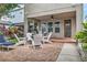 Inviting covered patio with stylish seating, a ceiling fan, and a charming brick-paved area for outdoor enjoyment at 7238 Milestone Dr, Apollo Beach, FL 33572