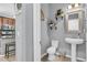 Well-appointed powder room with pedestal sink and decorative mirror at 7238 Milestone Dr, Apollo Beach, FL 33572