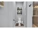 Contemporary toilet room featuring a toilet, shelving, and a modern walk-in shower at 7238 Milestone Dr, Apollo Beach, FL 33572