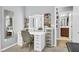 Bright vanity area with a lighted mirror, shelving for storage, and an adjacent doorway at 7238 Milestone Dr, Apollo Beach, FL 33572