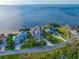 Stunning waterfront home with lush landscaping and circular driveway in a serene coastal setting at 812 Point Seaside Dr, Crystal Beach, FL 34681