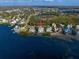 Aerial view of waterfront property featuring a beautiful home, pool, and beach access at 812 Point Seaside Dr, Crystal Beach, FL 34681