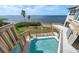 Backyard featuring a swimming pool, palm trees, beach access and ocean views at 812 Point Seaside Dr, Crystal Beach, FL 34681