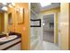 Bright bathroom featuring a single sink vanity, a tub, and tile flooring at 812 Point Seaside Dr, Crystal Beach, FL 34681