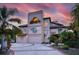 Elegant multi-story home showcasing a unique architectural design with a circular driveway at 812 Point Seaside Dr, Crystal Beach, FL 34681