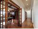 An opening from a hallway leads to a game room with a pool table and hardwood floors at 812 Point Seaside Dr, Crystal Beach, FL 34681