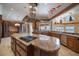 Spacious kitchen with custom island, granite countertops, stainless steel appliances, and ample storage at 812 Point Seaside Dr, Crystal Beach, FL 34681