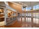 Spacious living room with hardwood floors, high ceilings, a bar, and ocean views at 812 Point Seaside Dr, Crystal Beach, FL 34681