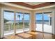 Bright living room with hardwood floors and sliding glass doors overlooking a coastal view at 812 Point Seaside Dr, Crystal Beach, FL 34681