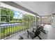 Relaxing screened balcony with comfortable seating overlooking a tranquil lake view at 9223 Brindlewood Dr, Odessa, FL 33556