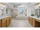Bright bathroom with dual vanities, a soaking tub, and a separate shower at 9223 Brindlewood Dr, Odessa, FL 33556