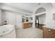 Bathroom showcasing a large tub, tile flooring, and double sinks at 9223 Brindlewood Dr, Odessa, FL 33556