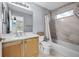 Well-lit bathroom featuring white tile, a shower-tub combination and vanity at 9223 Brindlewood Dr, Odessa, FL 33556