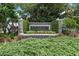 Community sign with stone pillars, landscaping, and clear community identification at 9223 Brindlewood Dr, Odessa, FL 33556